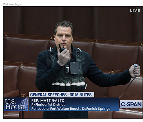 Satirical photo-illustration of Florida Representative Matt Gaetz 'giving a speech' on the floor of the House of Representatives on C-Span dressed in black wearing bombs wrapped around his midsection and speaking into a walkie-talkie as he bransishes a detonator.